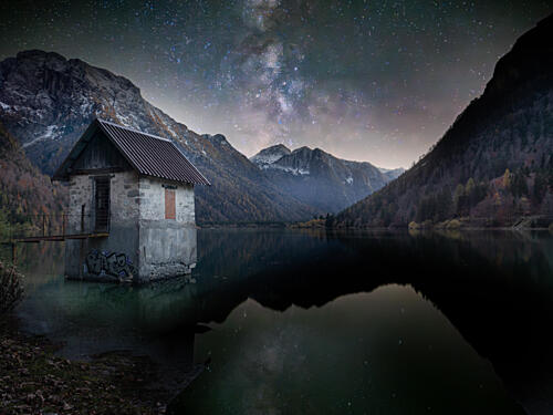 Milky Way over Lake House Art Print by Gregor Sinai