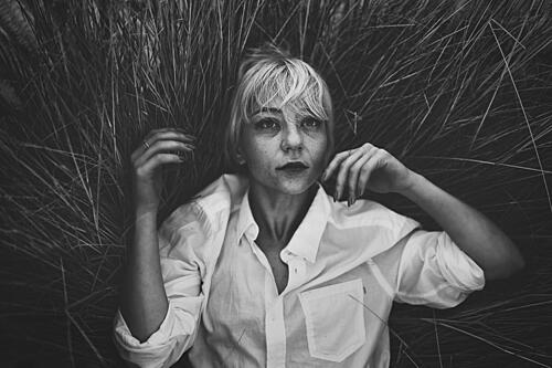Pensive Woman in Grass Art Print by Yuri Shepelev