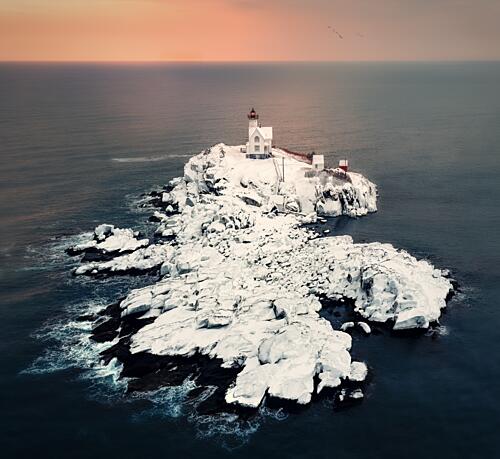 Snowy Lighthouse Island Sunset Art Print by Kai Dan