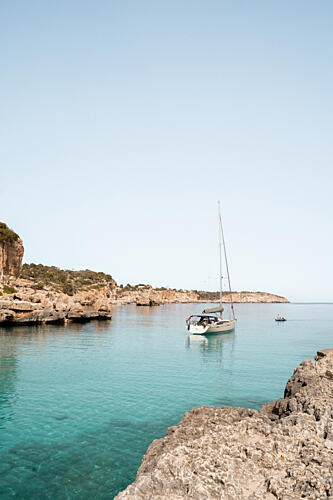 Sailboat in Turquoise Bay Art Print by Henrike Schenk