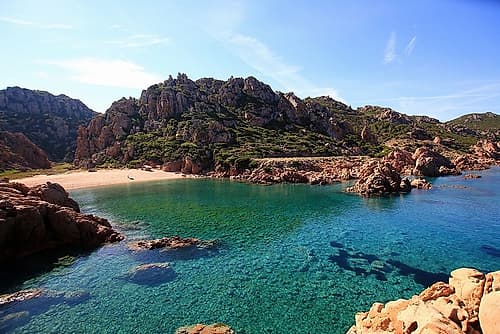 Crystalline Sea surrodunded by rocky hills Sardinia Art Print by Giovanni