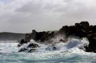 Strong waves crashing the black rocks Art Print
