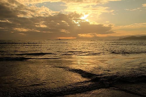 Golden Sea at Sunset with a lighthouse Art Print
