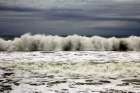 Waves crashing on the coast in a cloudy day Art Print