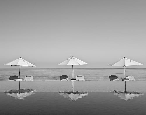 Umbrellas by the Sea Art Print
