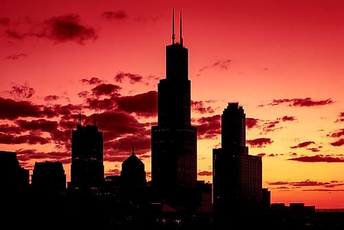 Chicagos Skyline appears in silhouette at sunset Landscape Print