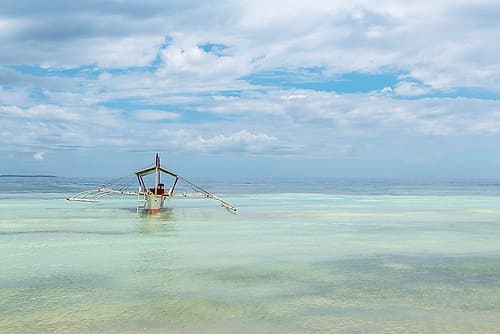 Outrigger Boat in Turquoise Water II Art Print by Richard Silver