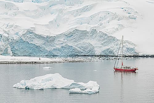 Red Sailboat Against Glacier Face Art Print