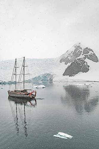 Schooner Beneath Snowy Peak Art Print