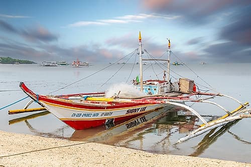 Colorful Bangka Boat Moored at Dock, Philippines Art Print by Richard Silver