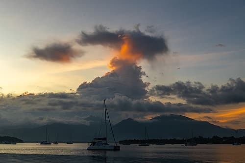 Sailboat at Dusk with Mountain Silhouette, Philippines Art Print