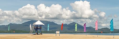 Beach Hut with Colorful Flags and Mountain View, Philippines Art Print