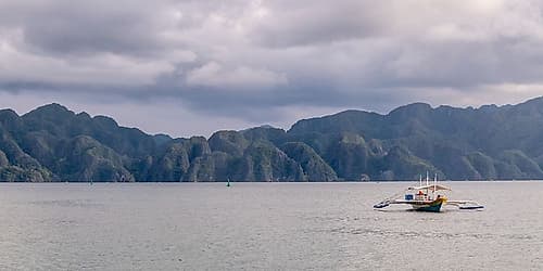 Bangka Boat with Limestone Mountain Range, El Nido, Palawan, Philippines Art Print