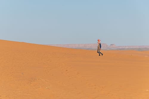 Person Walking Along Desert Dune Ridge, Sahara Desert, Morocco Art Print by Richard Silver