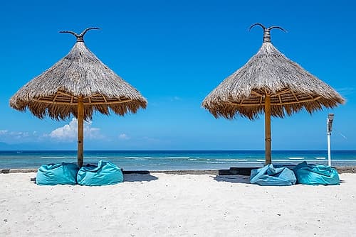 Thatched Beach Umbrellas with Teal Loungers, Gili Islands, Indonesia Art Print