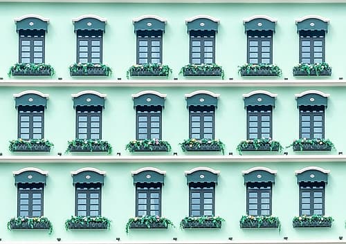 Green Shuttered Windows with Flower Boxes on Facade Art Print by Richard Silver