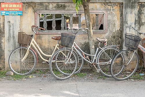 Vintage Bicycles Against Weathered Wall, Vietnam Art Print by Richard Silver