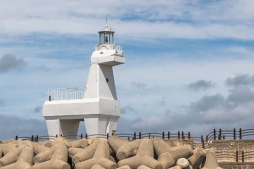 White Horse-Shaped Lighthouse on Rocky Jetty, Jeju Island, South Korea Art Print