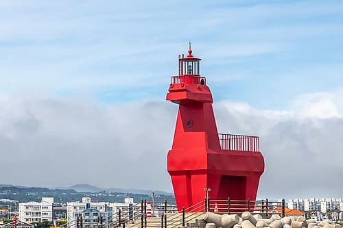 Red Horse-Shaped Lighthouse on Rocky Jetty, Jeju Island, South Korea Art Print