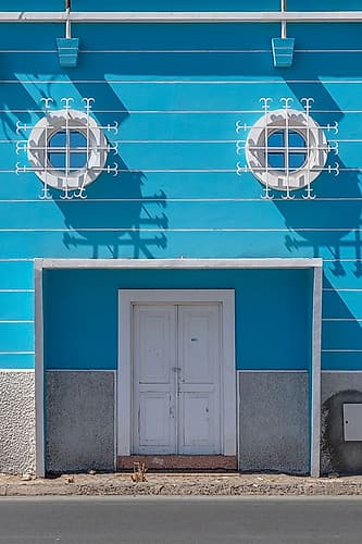 Blue Building Facade with Round Porthole Windows Art Print