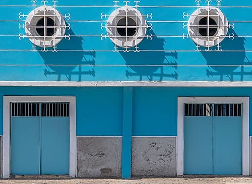 Blue Colonial Facade with Porthole Windows and Doors Art Print