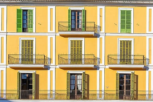 Yellow Mediterranean Facade with Colorful Shutters Art Print by Richard Silver
